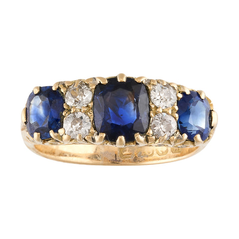 A Victorian three-stone Sapphire and Diamond Ring, 18ct. Yellow Gold